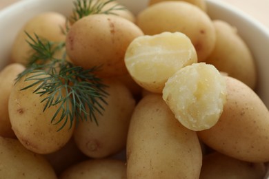 Boiled potatoes with dill in bowl, closeup