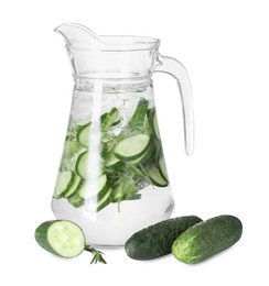 Refreshing cucumber water with rosemary in jug and vegetables isolated on white