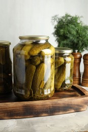 Photo of Pickled cucumbers in jars on grey table