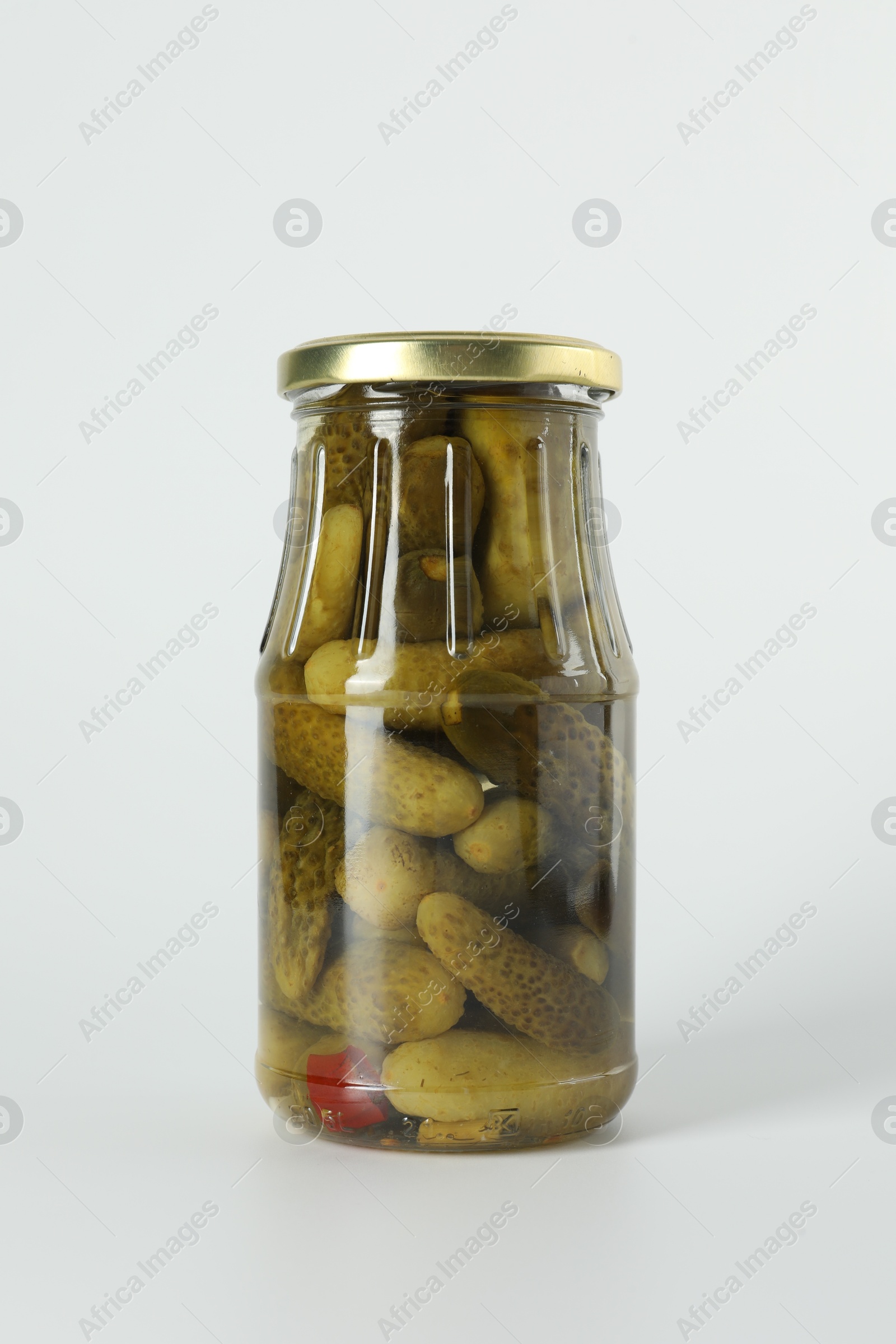 Photo of Pickled cucumbers in jar on light background