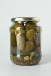 Photo of Pickled cucumbers in jar on light background