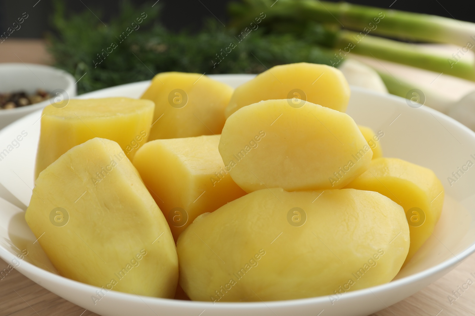 Photo of Boiled potatoes in bowl on table, closeup