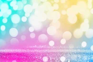 Image of Bright background with sparkling glitter and bokeh effect, closeup. Backdrop for party invitations or holiday cards