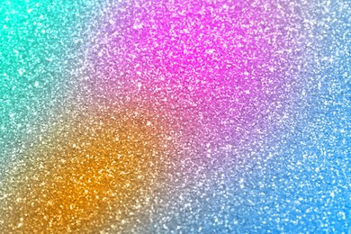 Bright colorful sparkling glitter, closeup. Background for party invitations or holiday cards