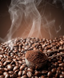 Image of Freshly roasted beans and ground coffee on dark background, closeup