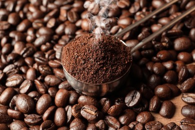 Freshly roasted beans and ground coffee as background, closeup