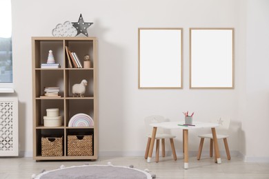 Image of Room for child with blank pictures on wall. Interior design