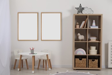 Room for child with blank pictures on wall. Interior design