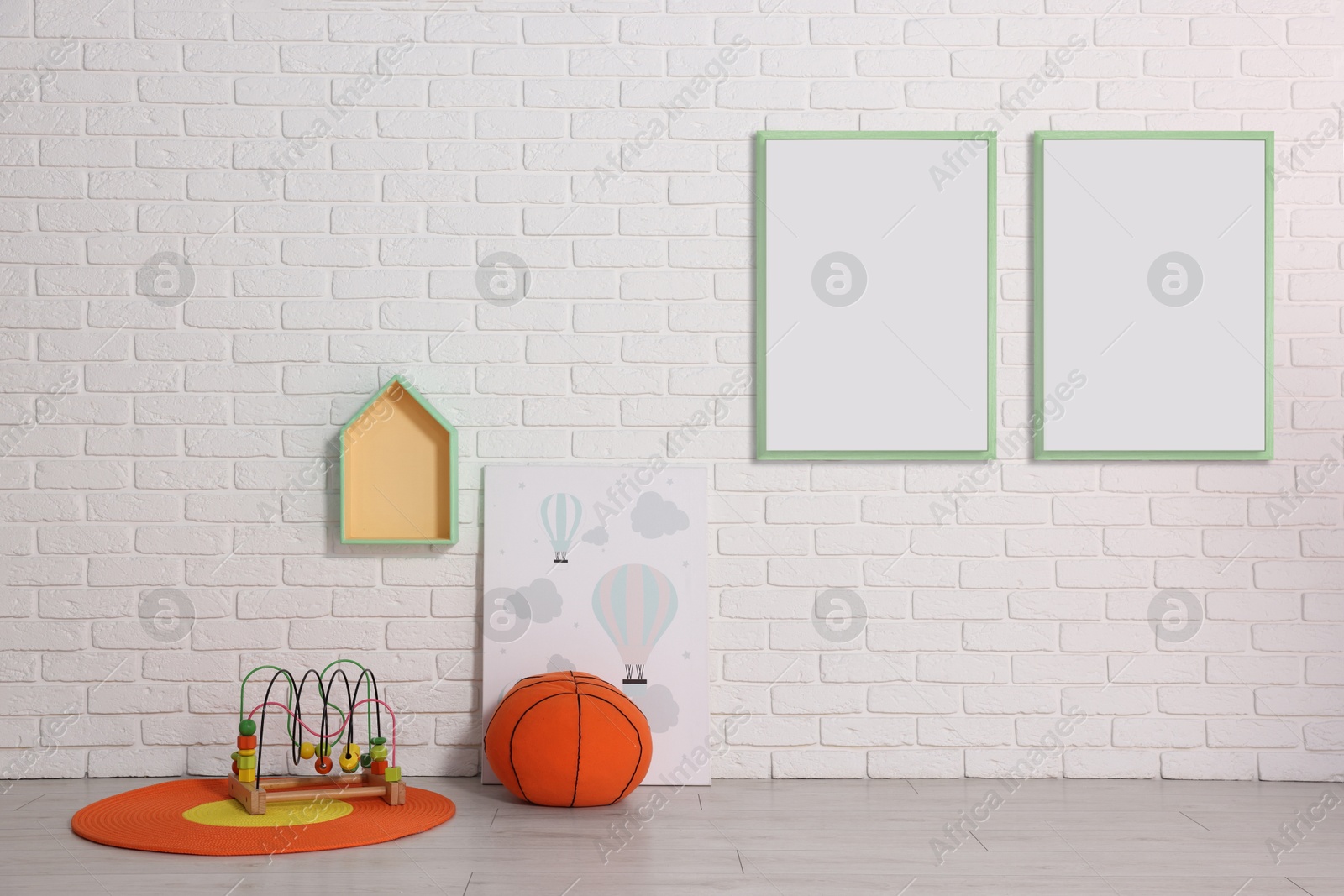 Image of Room for child with blank pictures on white brick wall. Interior design