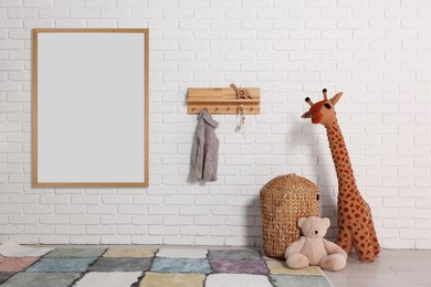 Image of Room for child with blank picture on white brick wall. Interior design