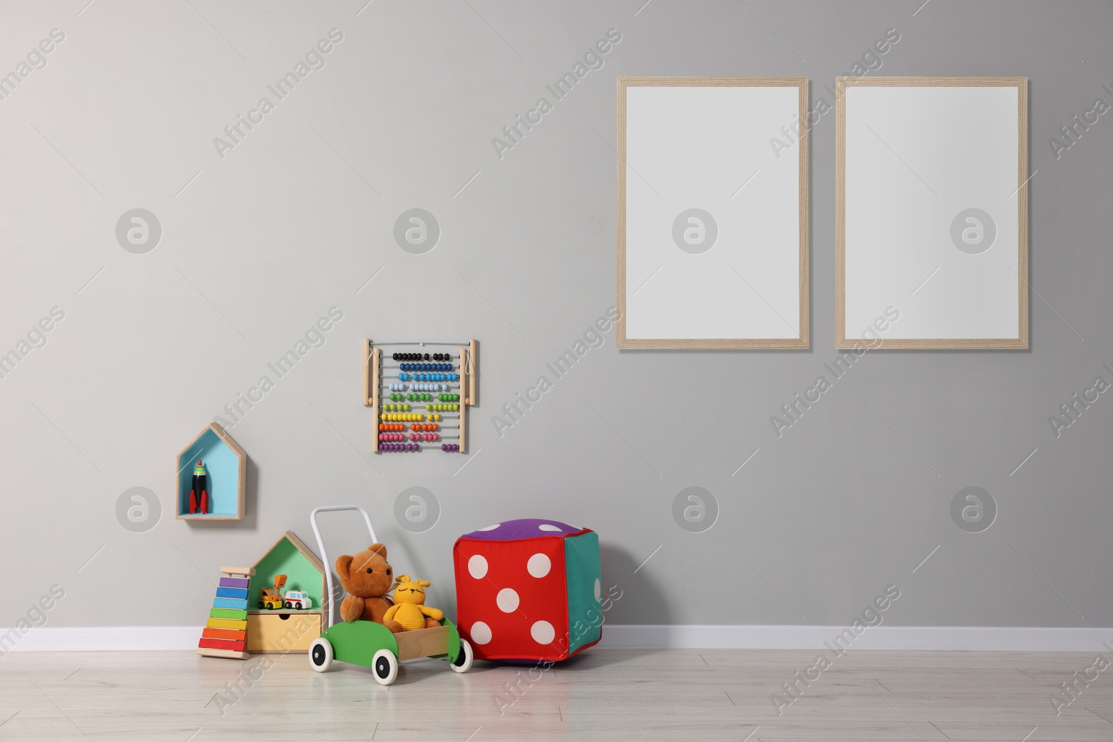 Image of Room for child with blank pictures on grey wall. Interior design