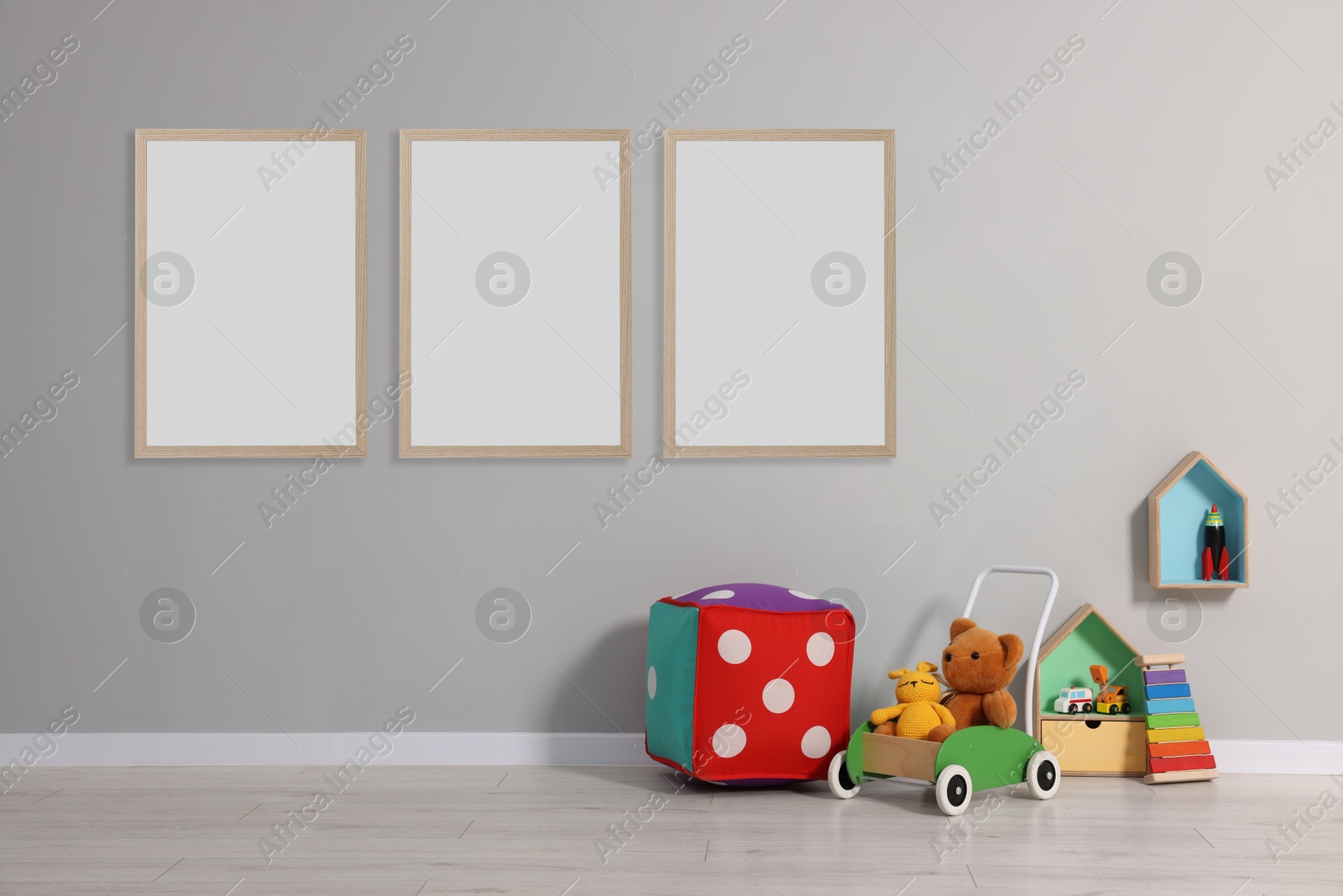 Image of Room for child with blank pictures on grey wall. Interior design
