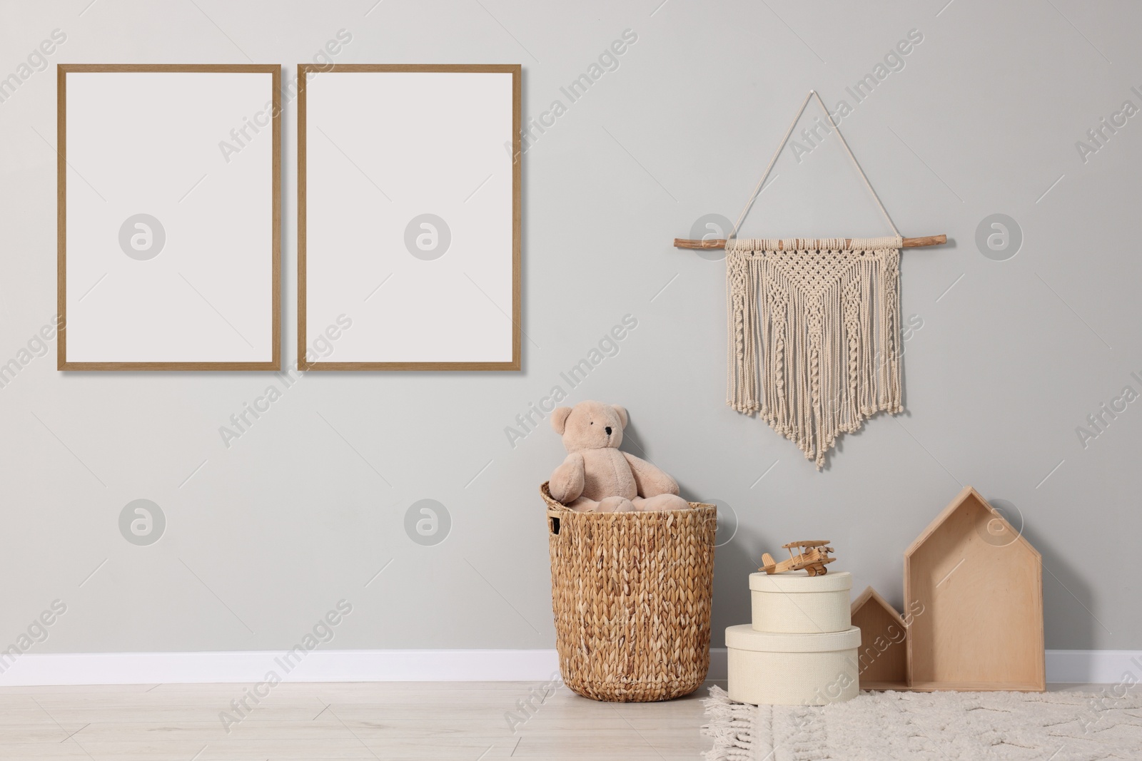 Image of Room for child with blank pictures on grey wall. Interior design