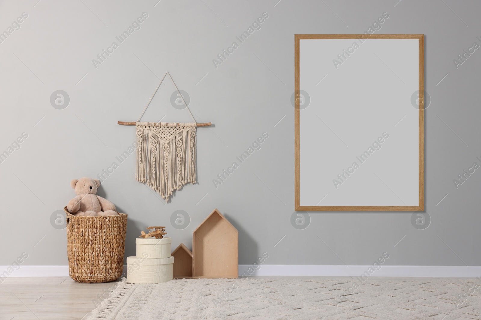 Image of Room for child with blank picture on grey wall. Interior design
