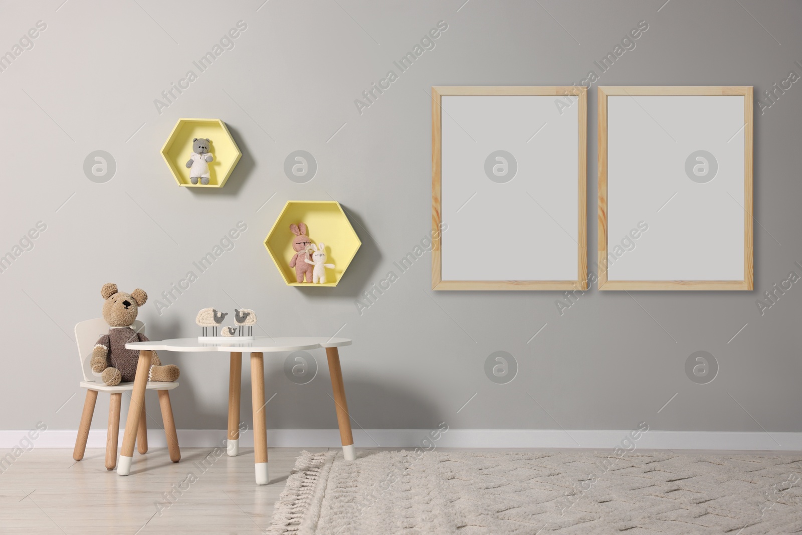 Image of Room for child with blank pictures on grey wall. Interior design