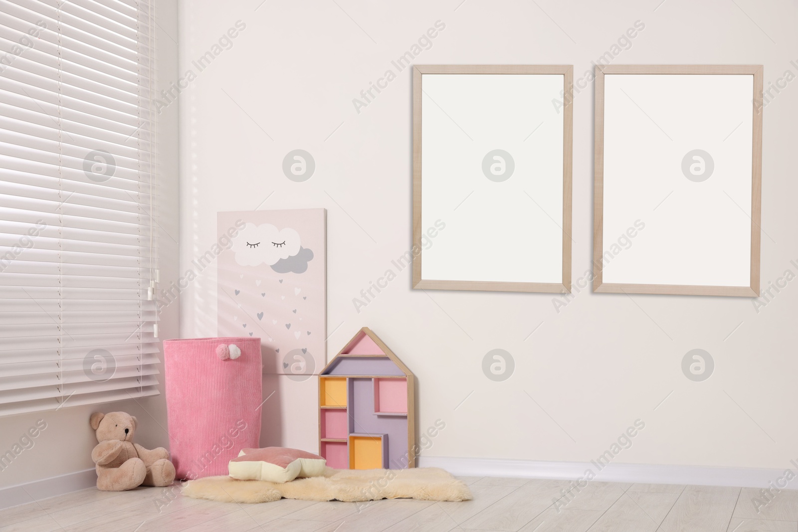 Image of Room for child with blank pictures on wall. Interior design