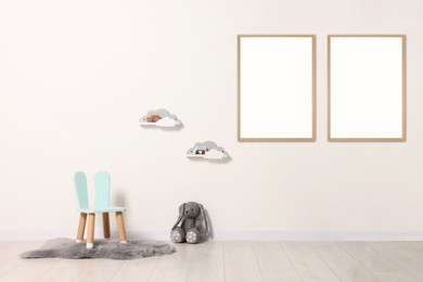 Image of Room for child with blank pictures on wall. Interior design