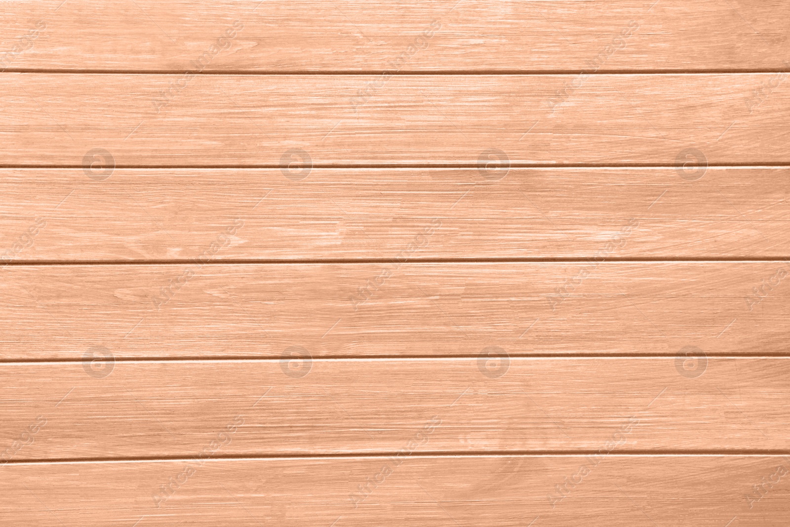 Image of Wooden surface of peach fuzz color, top view. Trendy shade of 2024 year