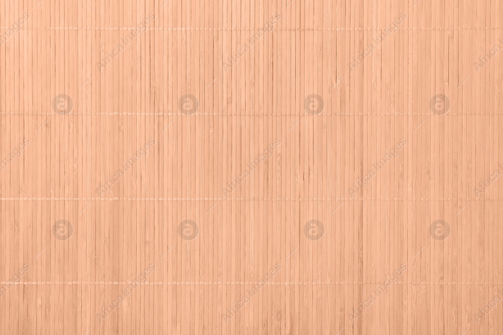 Image of Peach fuzz color bamboo mat, top view. Trendy shade of 2024 year