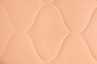 Peach fuzz color textile surface, closeup. Trendy shade of 2024 year