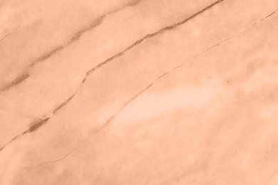 Image of Stone surface of peach fuzz color, top view. Trendy shade of 2024 year