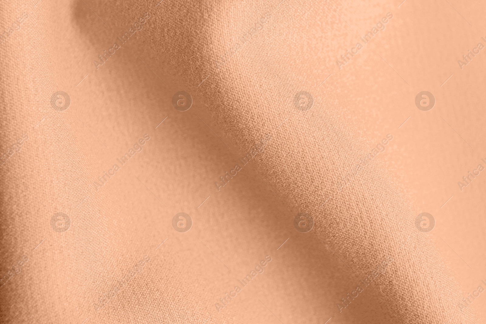 Image of Peach fuzz color fabric, top view. Trendy shade of 2024 year