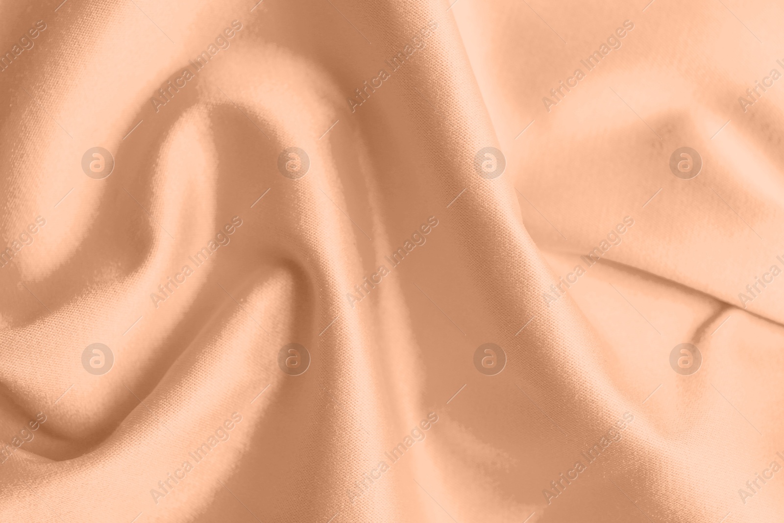 Image of Peach fuzz color silk, top view. Trendy shade of 2024 year