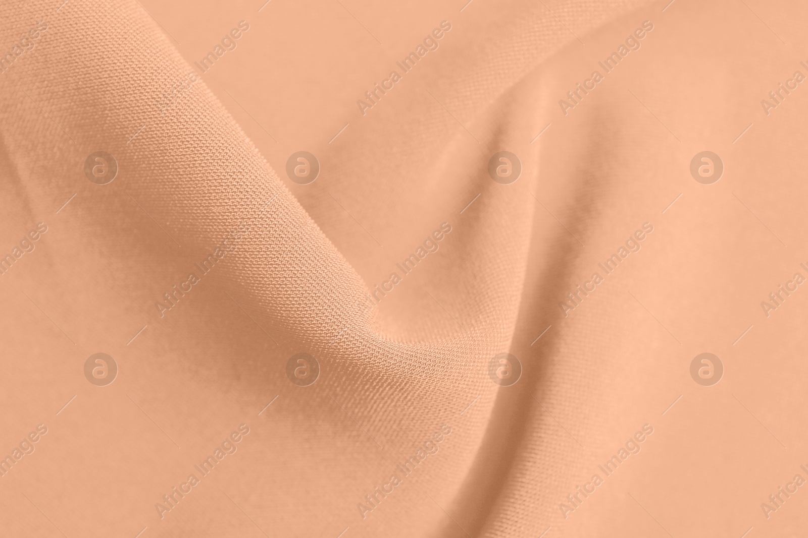 Image of Peach fuzz color fabric, top view. Trendy shade of 2024 year