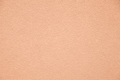 Image of Peach fuzz textured surface, closeup. Trendy shade of 2024 year