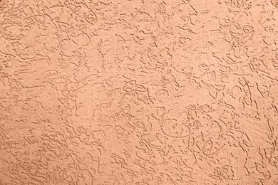 Peach fuzz textured surface, closeup. Trendy shade of 2024 year