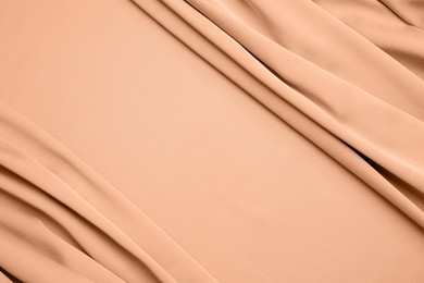 Peach fuzz color silk, top view. Trendy shade of 2024 year
