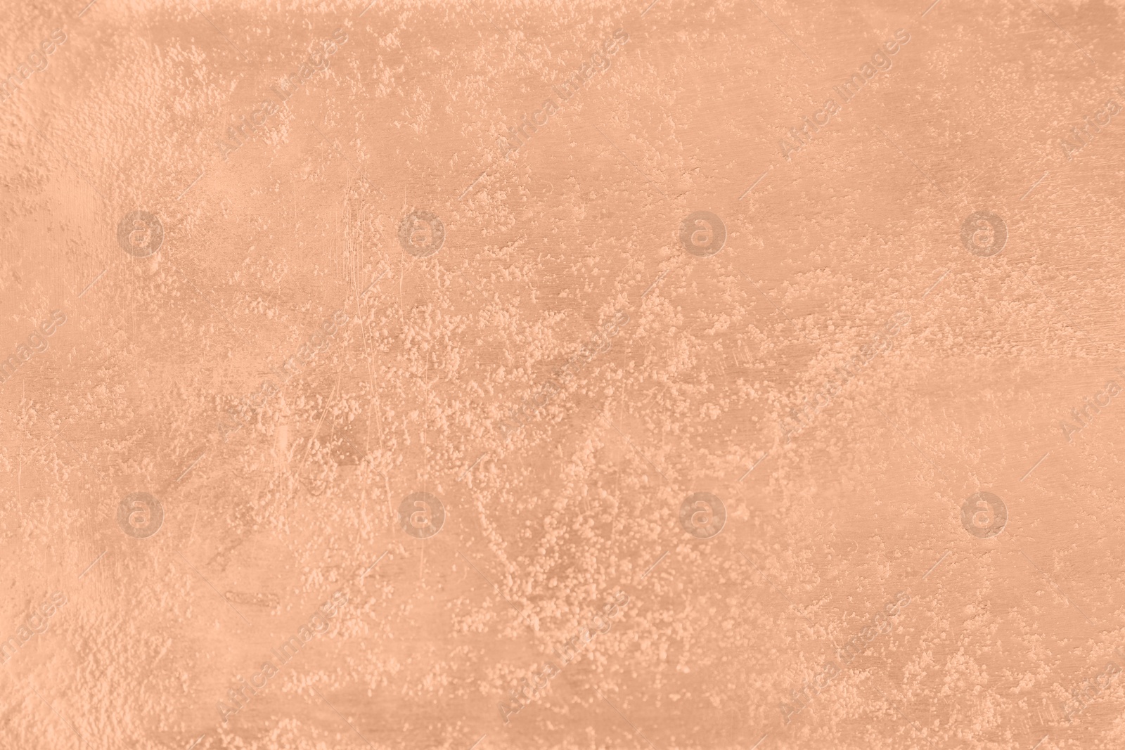 Image of Stone surface of peach fuzz color, top view. Trendy shade of 2024 year