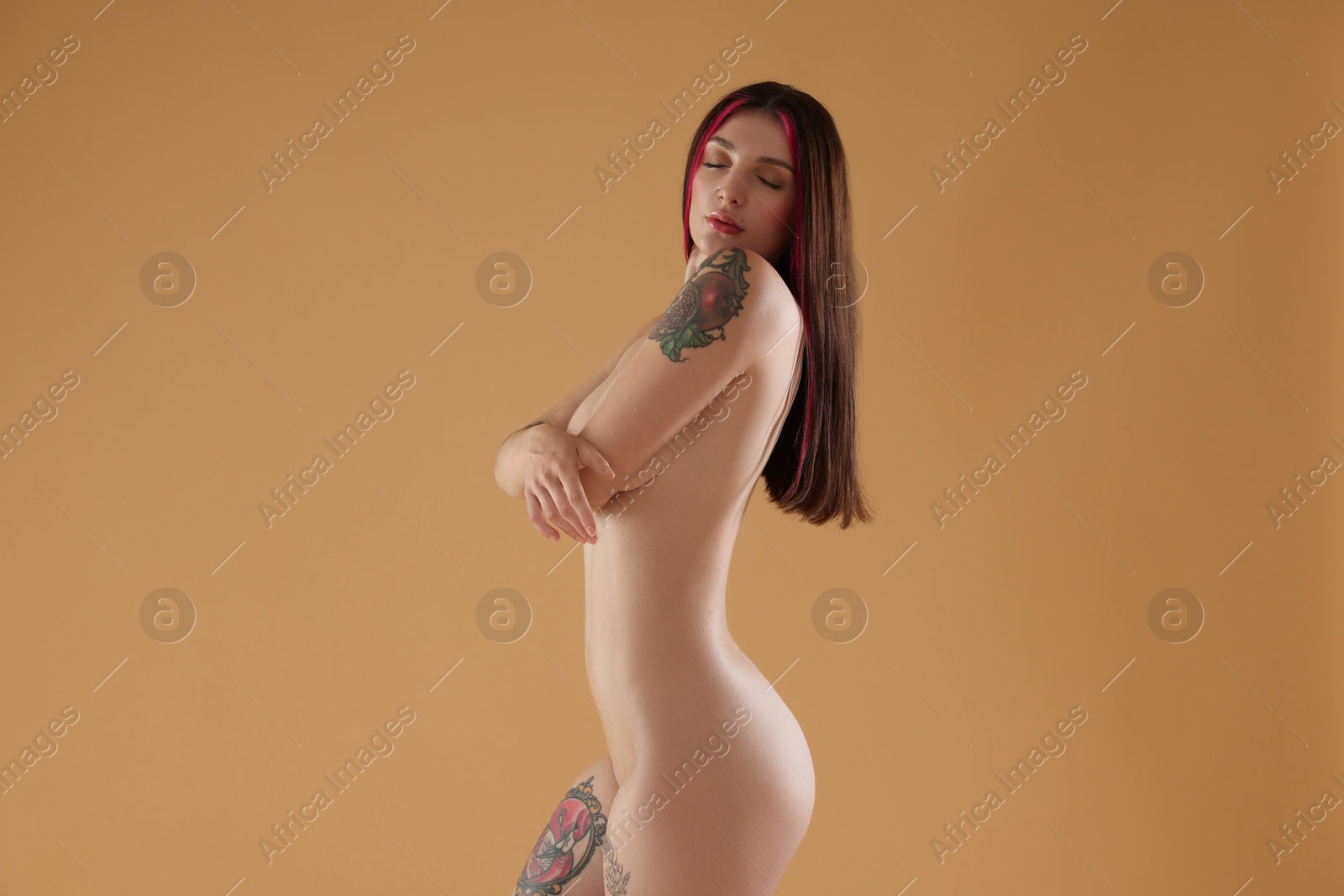 Photo of Sexy nude woman posing on beige background