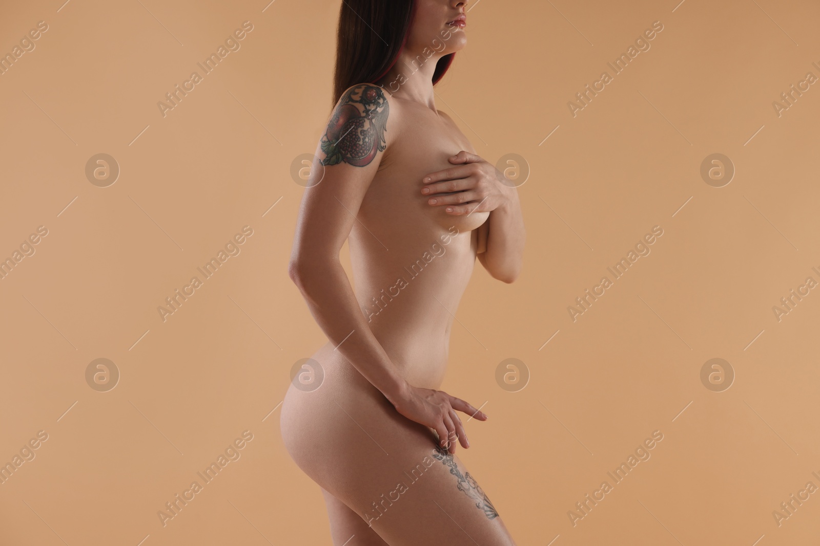 Photo of Nude woman on beige background, closeup view