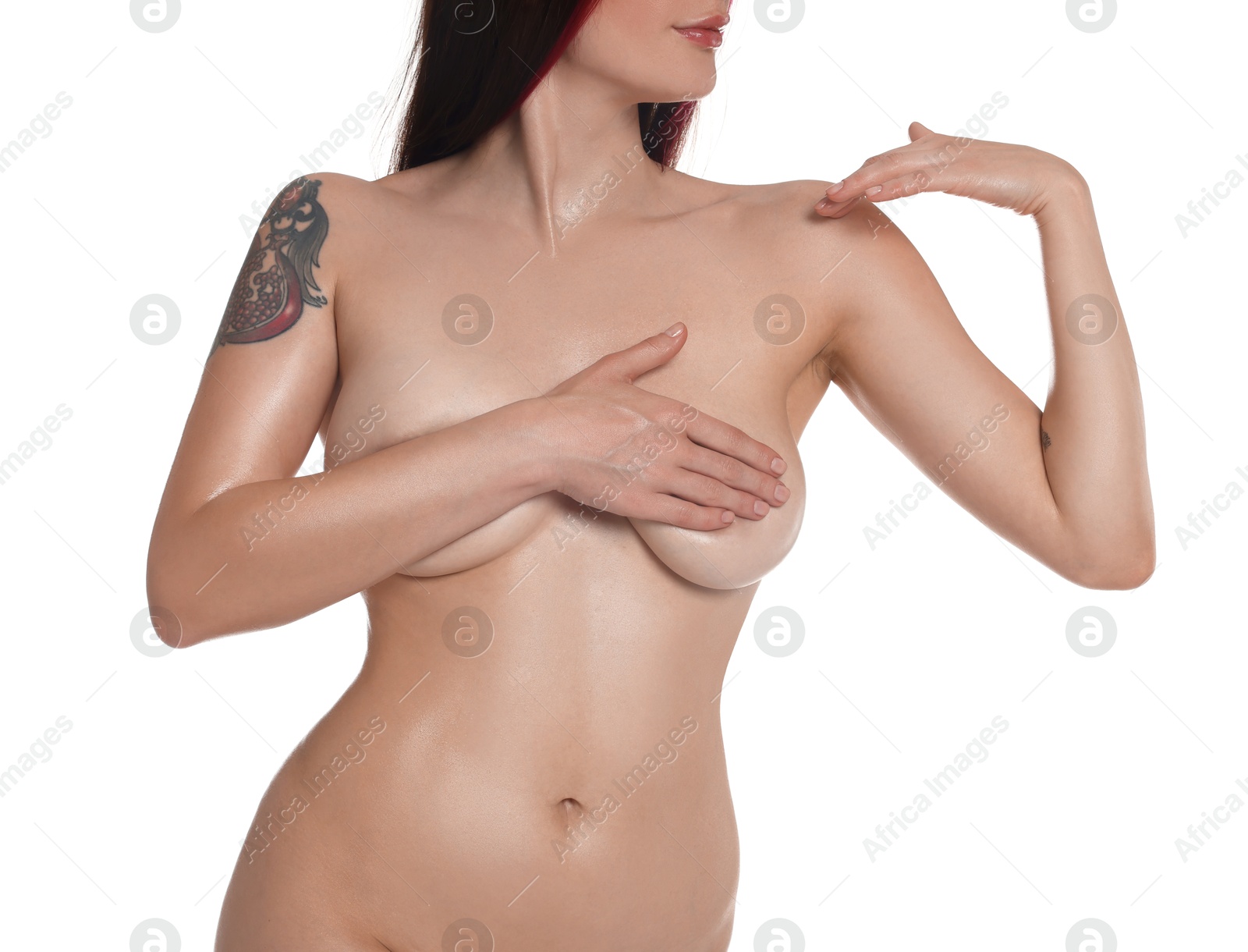 Photo of Nude woman with tattoos posing on white background, closeup