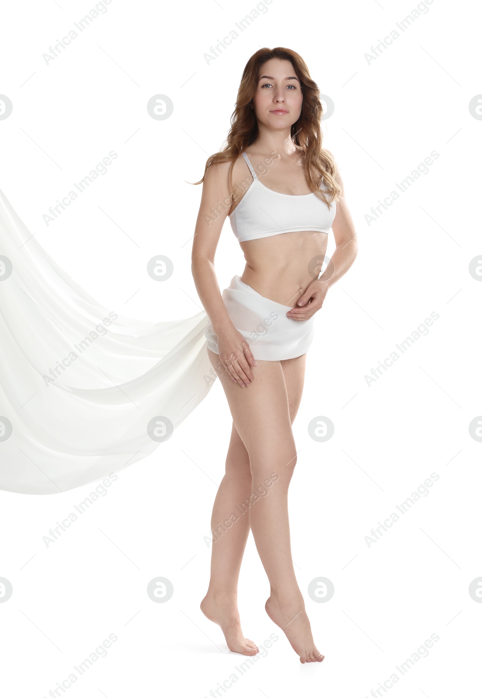 Photo of Woman covering her slim body with silk fabric against white background