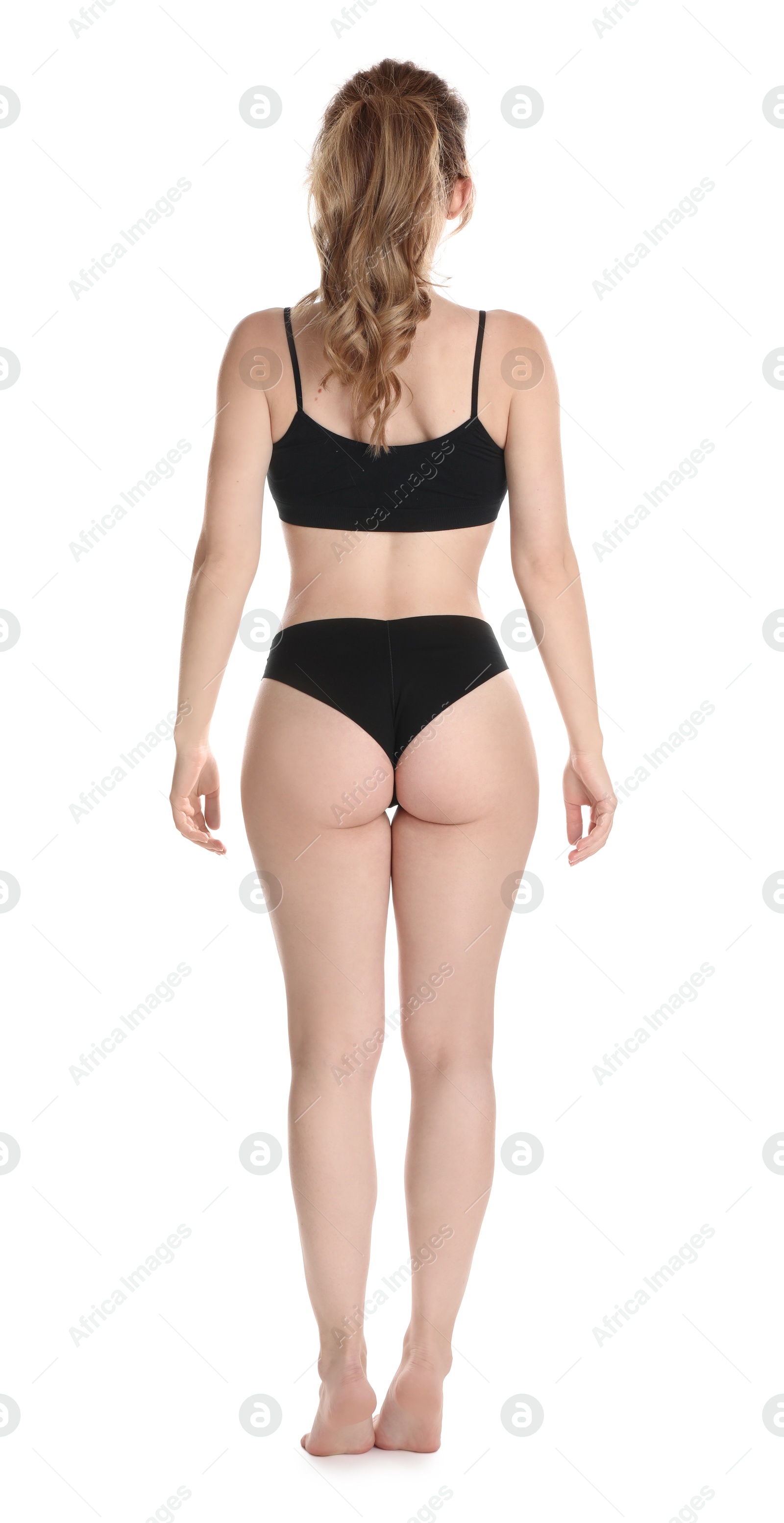 Photo of Woman with slim body posing on white background, back view