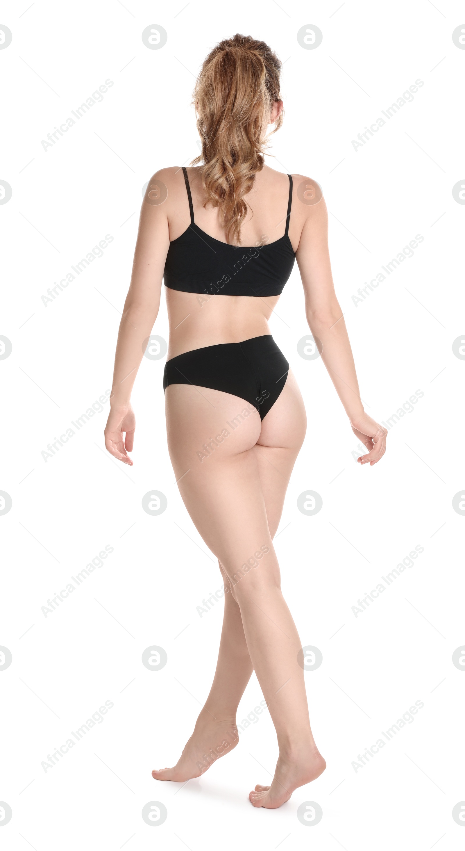 Photo of Woman with slim body posing on white background, back view