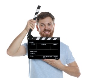 Photo of Making movie. Smiling man with clapperboard on white background