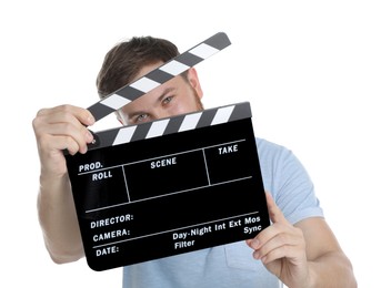 Photo of Making movie. Man with clapperboard on white background