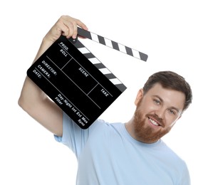 Photo of Making movie. Smiling man with clapperboard on white background