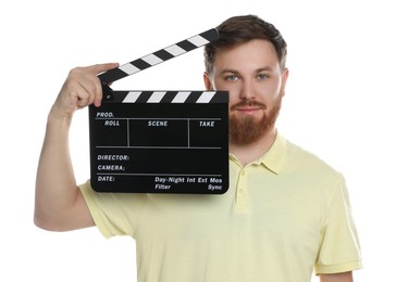 Making movie. Man with clapperboard on white background