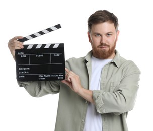 Photo of Making movie. Man with clapperboard on white background