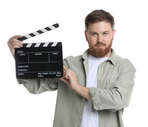 Making movie. Man with clapperboard on white background