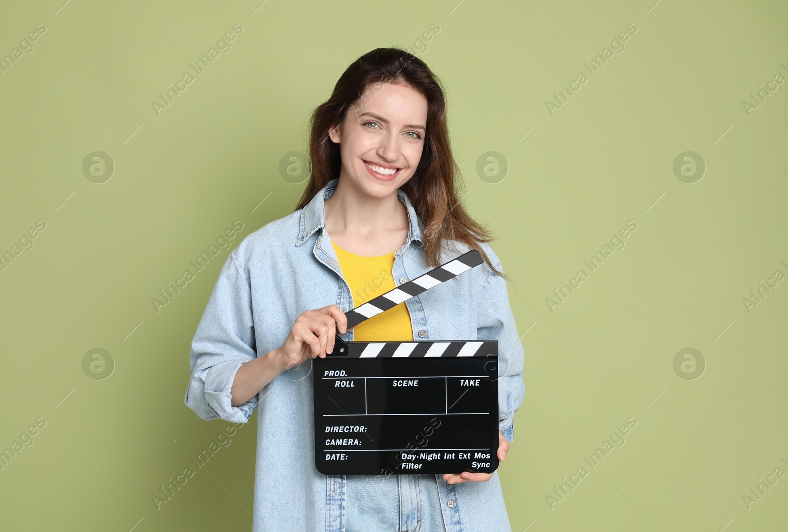 Photo of Making movie. Smiling woman with clapperboard on green background