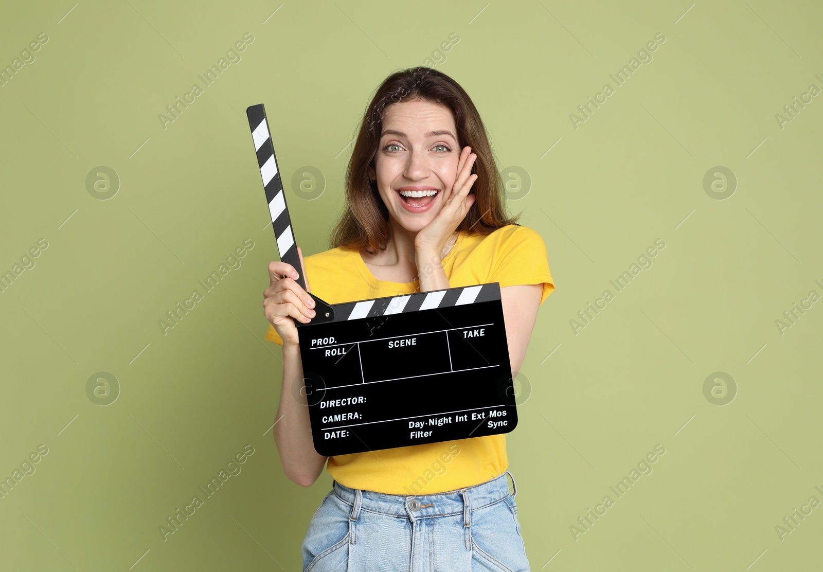 Photo of Making movie. Smiling woman with clapperboard on green background