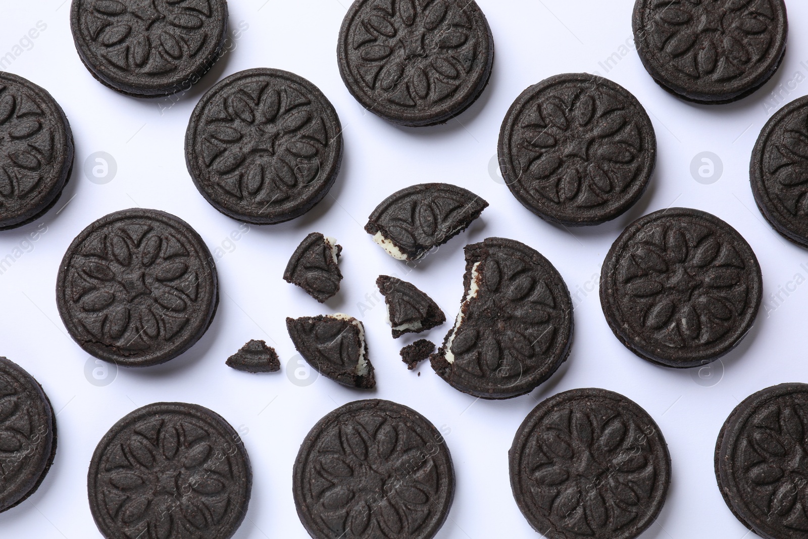 Photo of Tasty sweet sandwich cookies on white background, flat lay