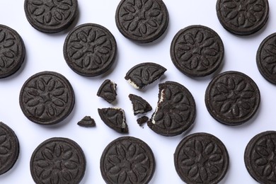 Photo of Tasty sweet sandwich cookies on white background, flat lay