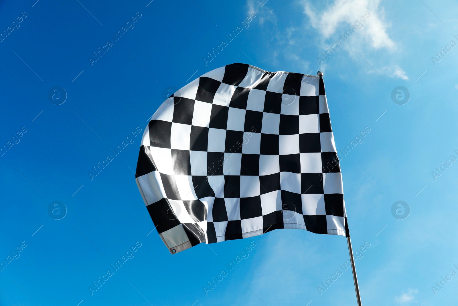 Photo of One checkered flag against blue sky outdoors