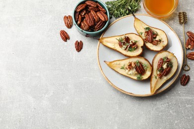 Photo of Tasty baked pears with nuts, blue cheese, thyme and honey on light grey table, top view. Space for text